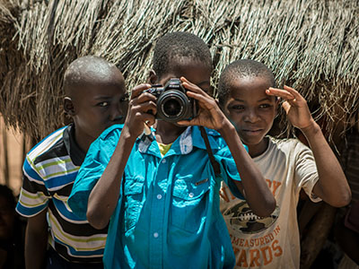 Children in Africa holding a camera