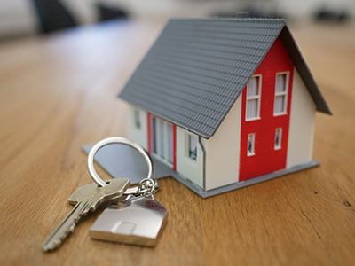 A house keychain and a key