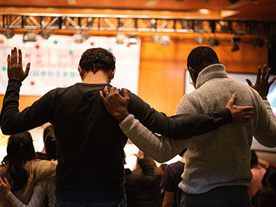 Two men lifting their hands in worship