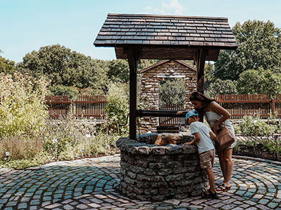 Two people looking into a well