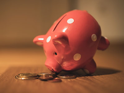 A piggy bank looking at coins