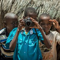 Children in Africa holding a camera